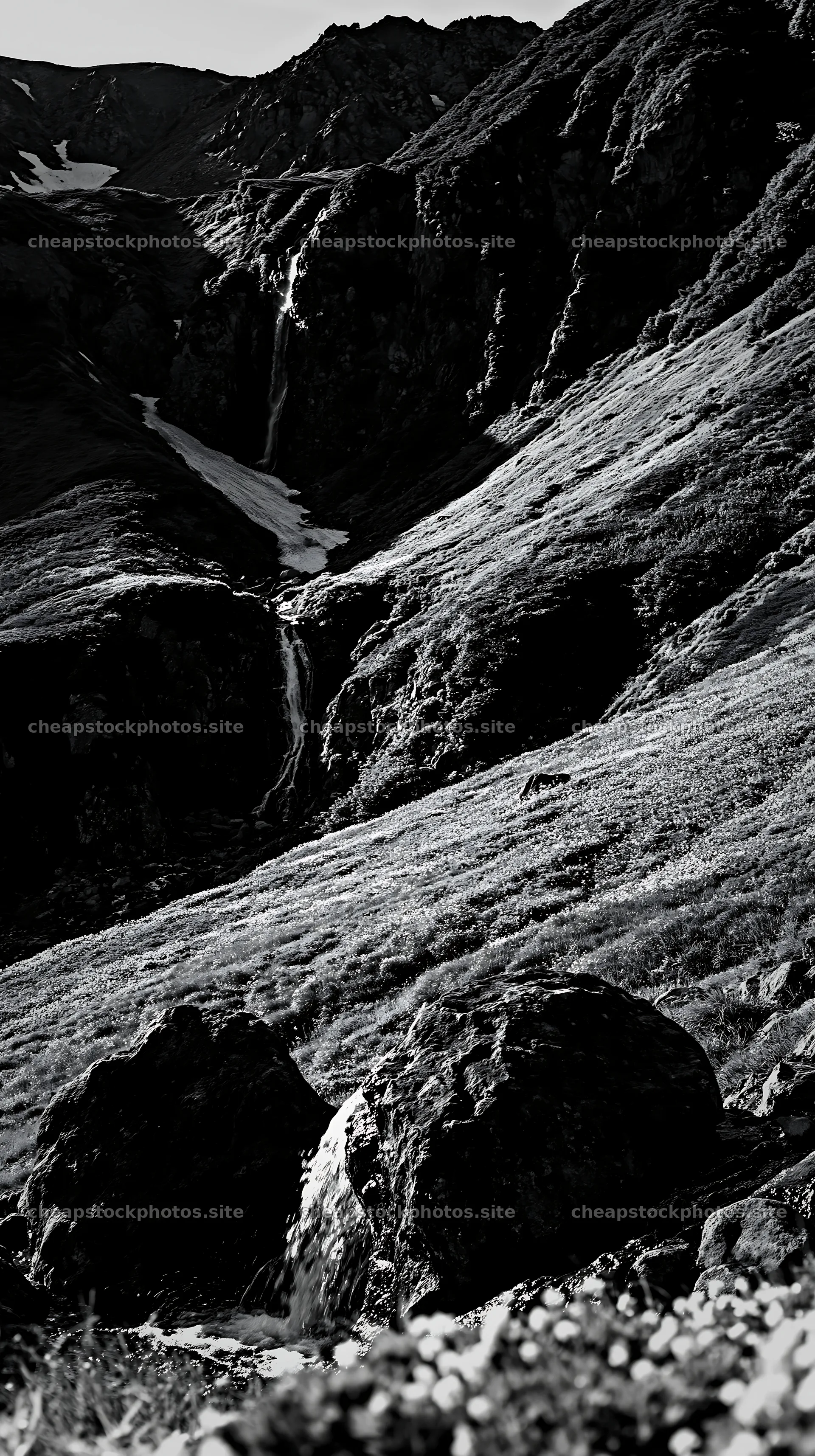Toyama alpine meadow snowmelt rock foreground with waterfall – stock photos 5938x10608