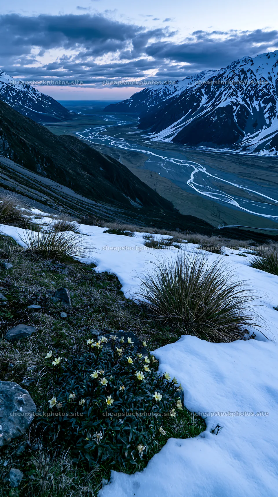Snowmelt meadow in valley with mountains and river at dusk – stock photos 5938x10608