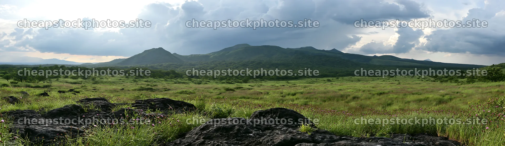 Kumamoto volcanic meadow with dark rocks and green landscape – stock photos 14762x4268