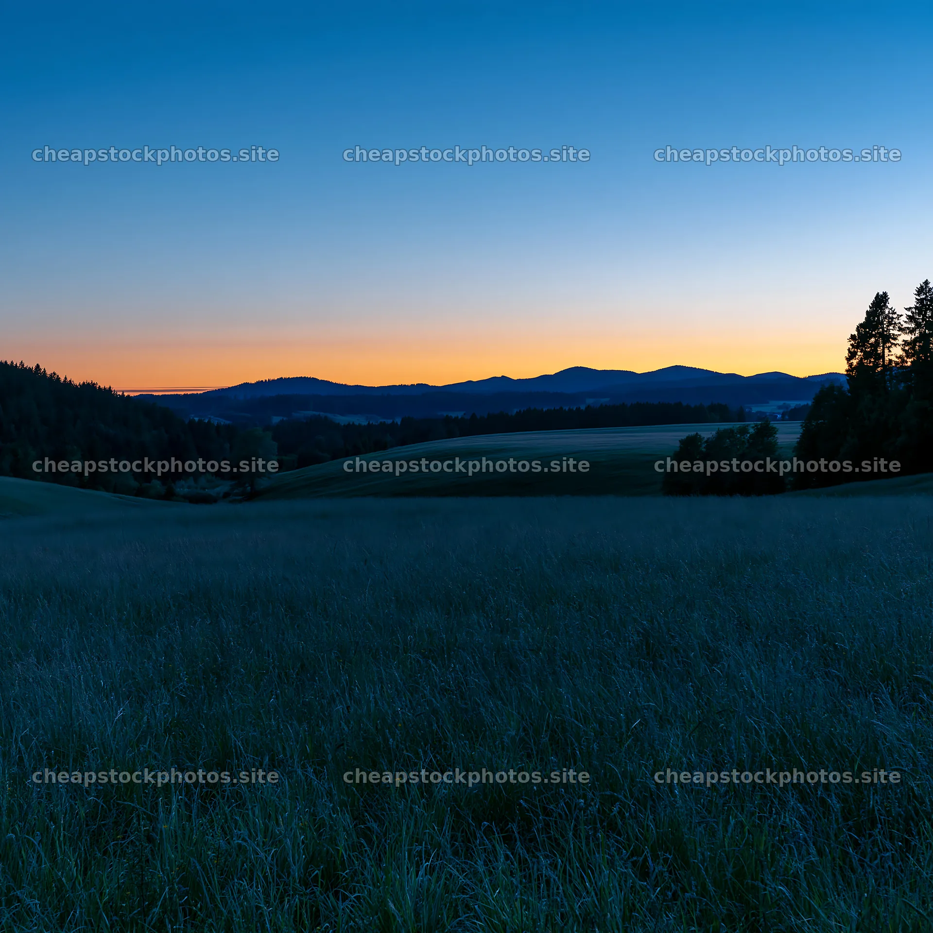 Rolling meadows at dusk with mountains in the background – stock photos 7938x7938