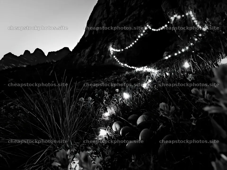 Christmas lights beside cave in meadow at dusk – stock photos 9174x6866