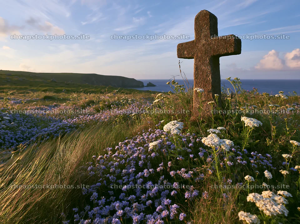 Christian cross at sunrise over meadow with flowers – stock photos 9174x6866