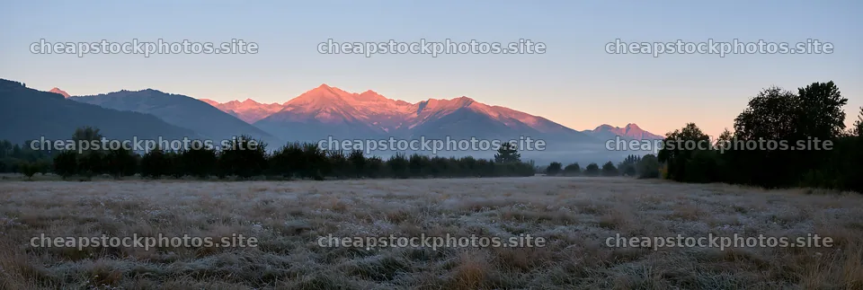 Highland apple meadow with mountains and early morning light – stock photos 13690x4602