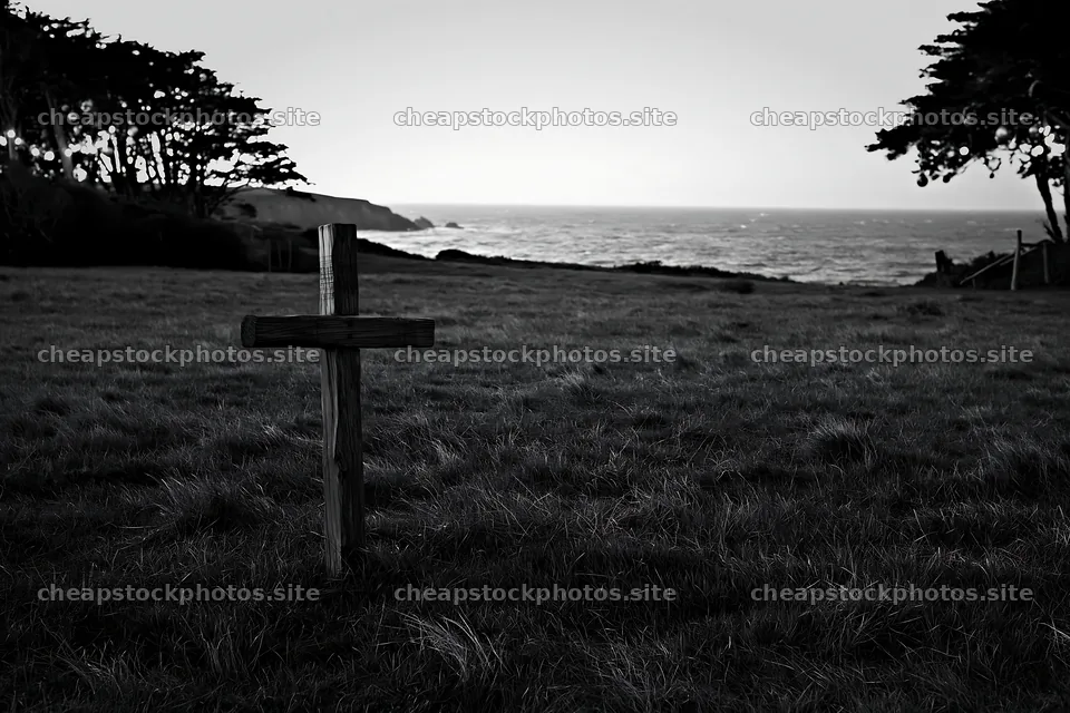 Cross in a meadow near the ocean at dusk – stock photos 9722x6480