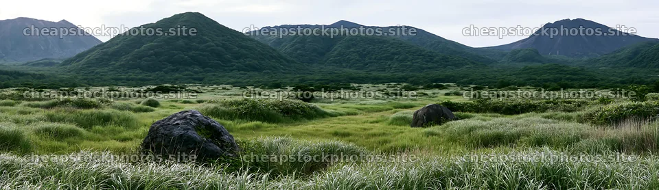 Aomori meadow with boulders under cloudy sky – stock photos 14762x4268
