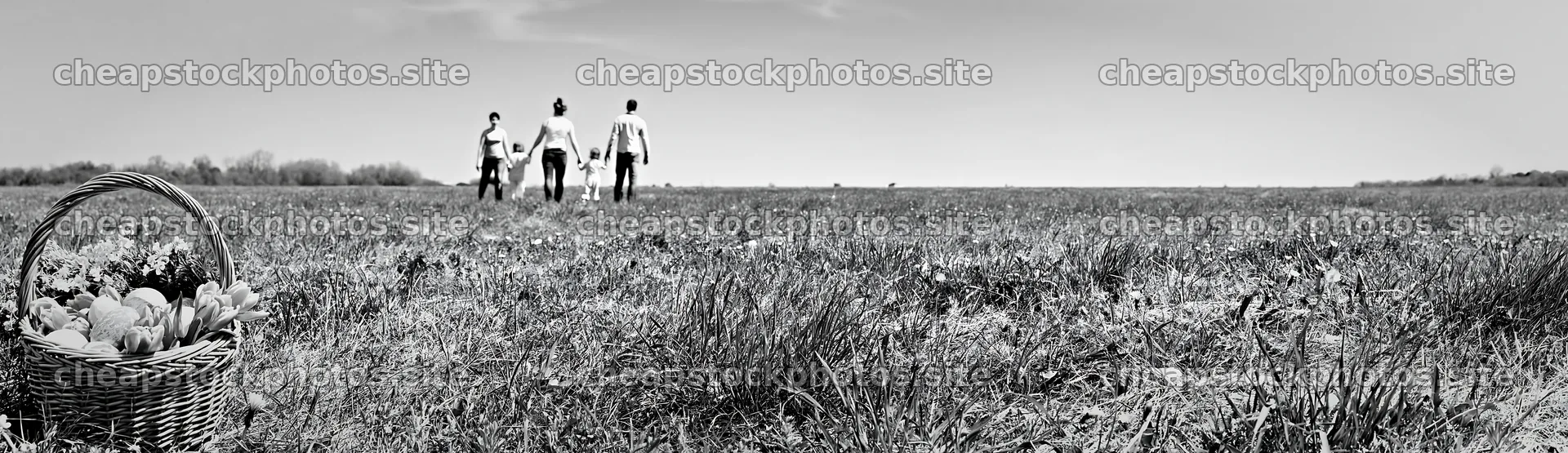 Easter basket in a meadow with people walking – stock photos 14762x4268