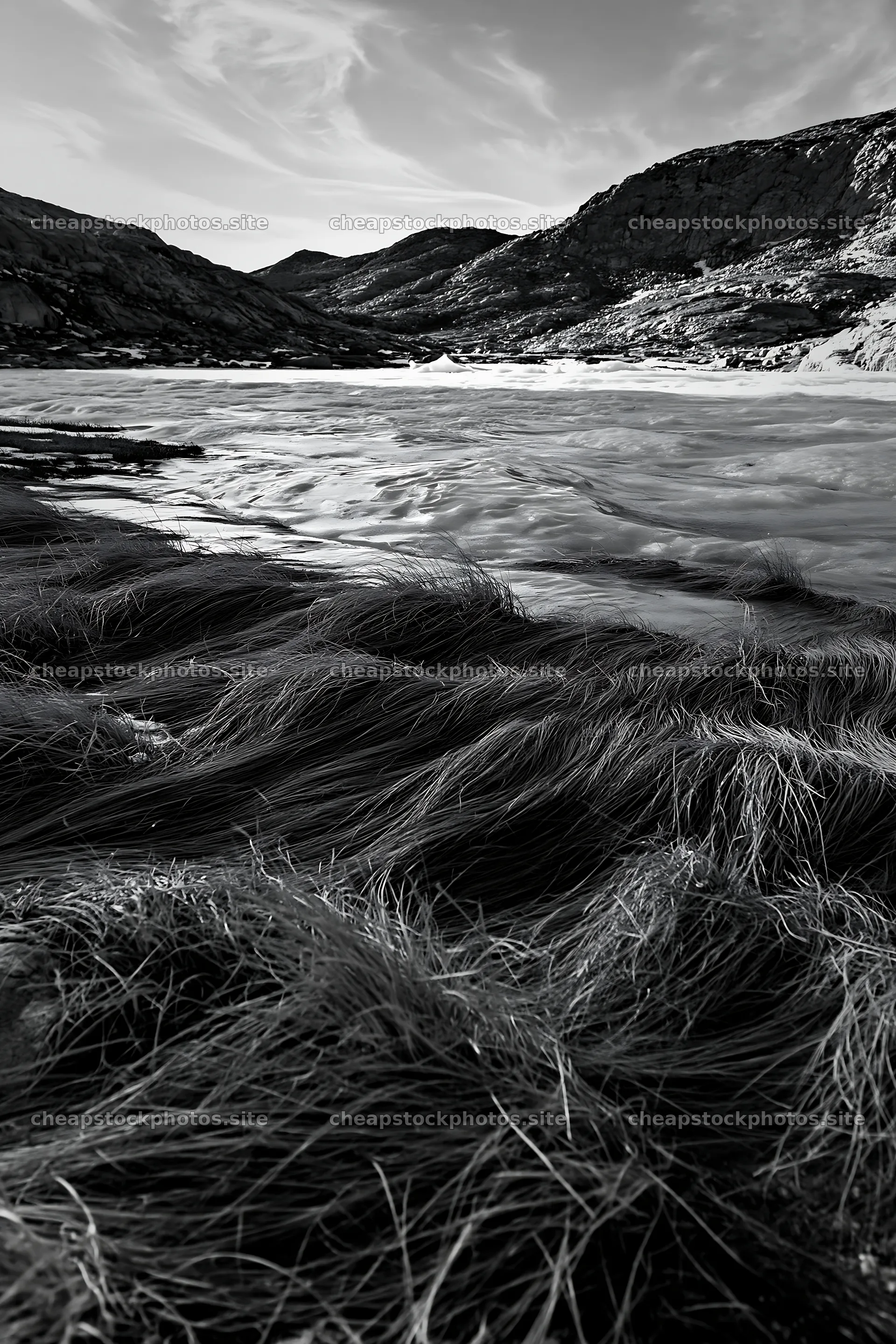 Frozen tarn meadow with grass and mountains in the background – stock photos 6480x9722