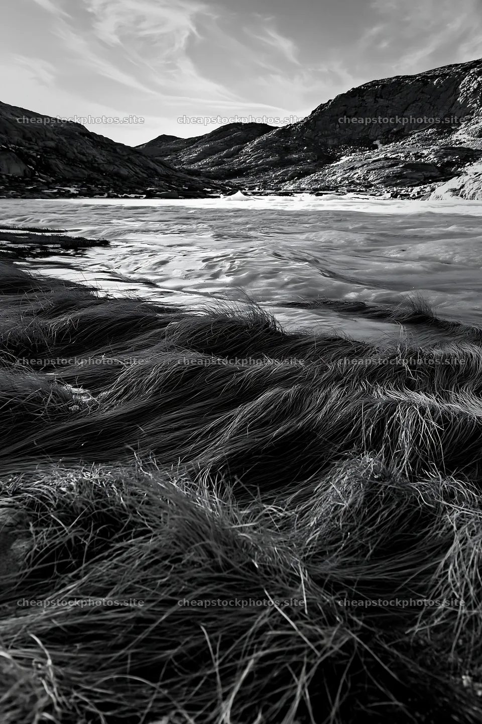 Frozen tarn meadow with grass and mountains in the background – stock photos 6480x9722