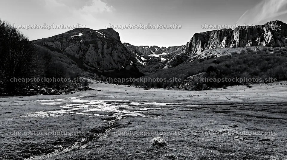 Meadow beneath crags with streams and rocky cliffs – stock photos 10608x5938