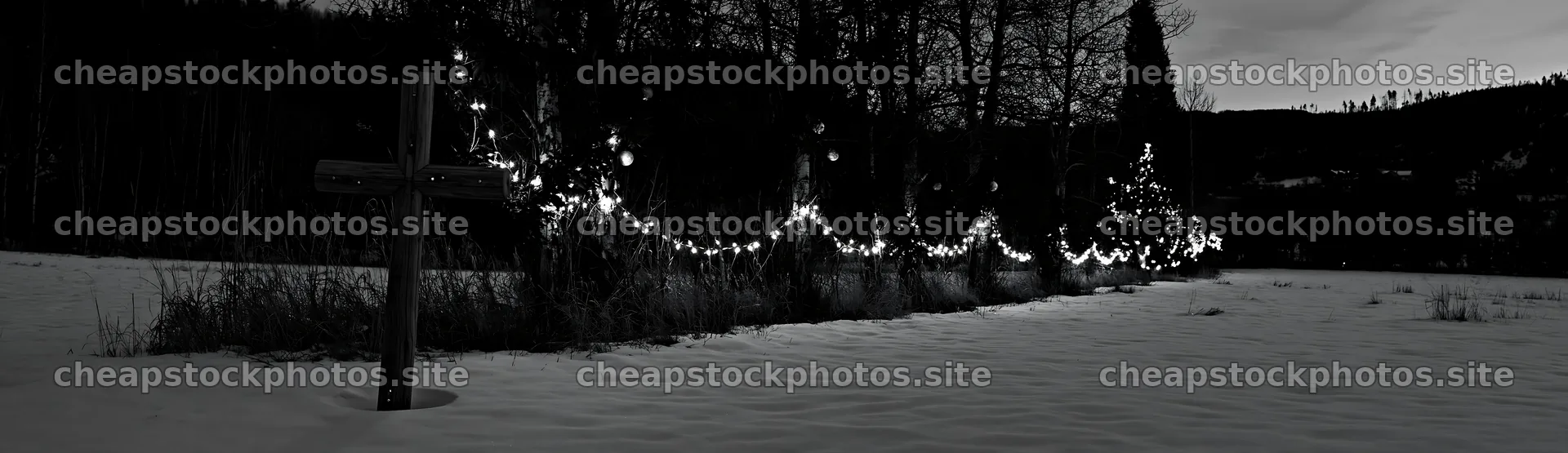 Rustic Christian cross in winter meadow with lights – stock photos 14762x4268
