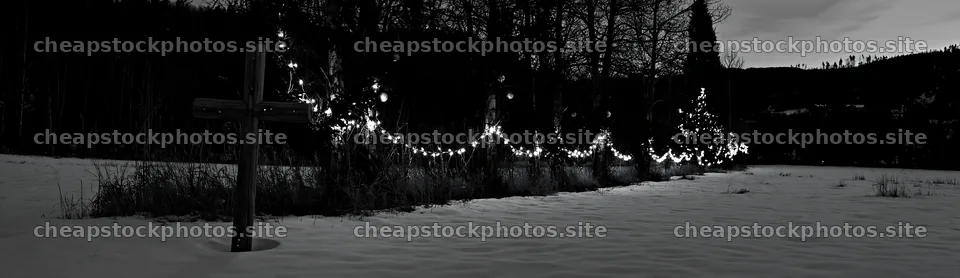 Rustic Christian cross in winter meadow with lights – stock photos 14762x4268