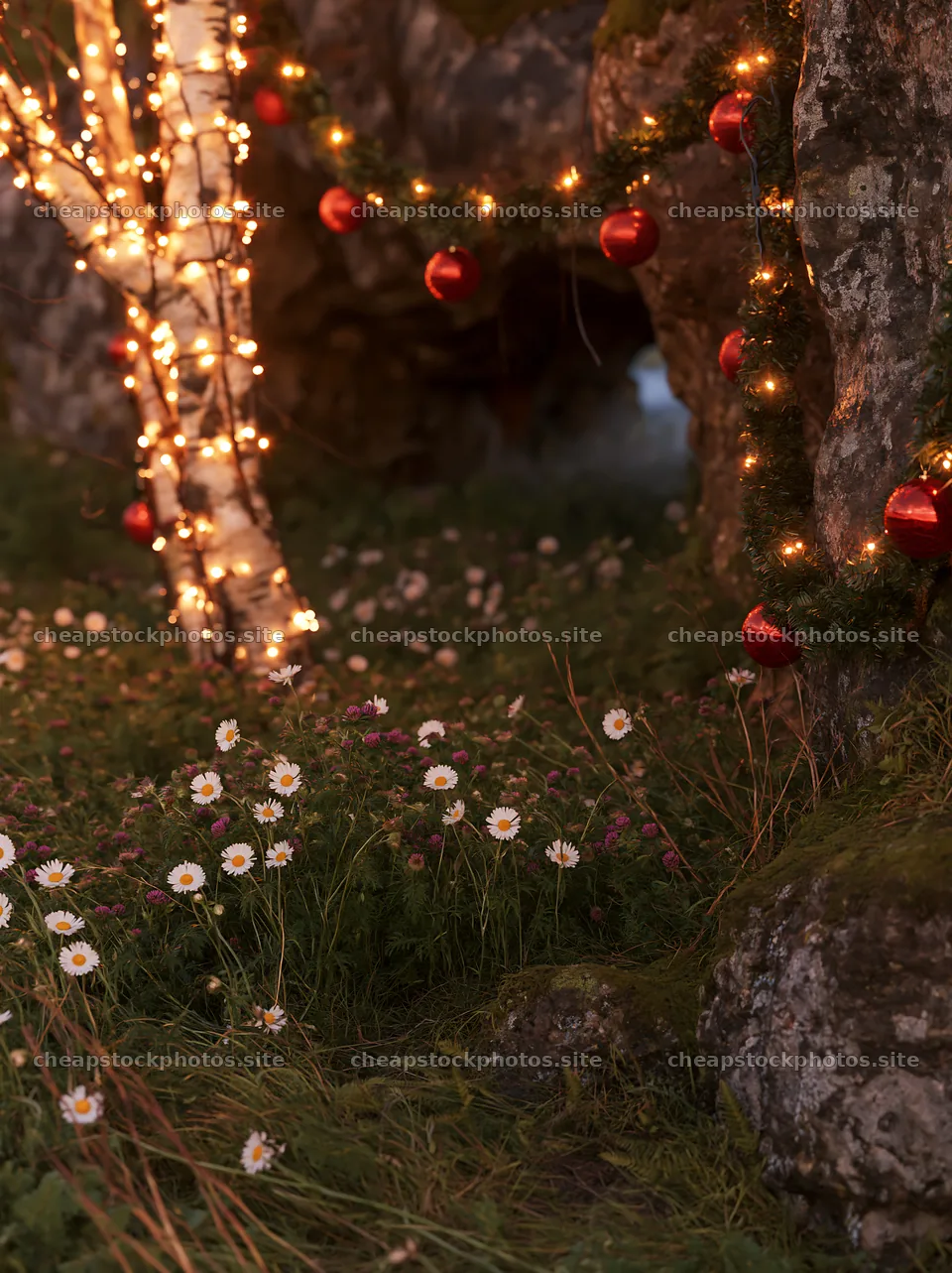 Christmas ornaments near cave in meadow with flowers – stock photos 6866x9174