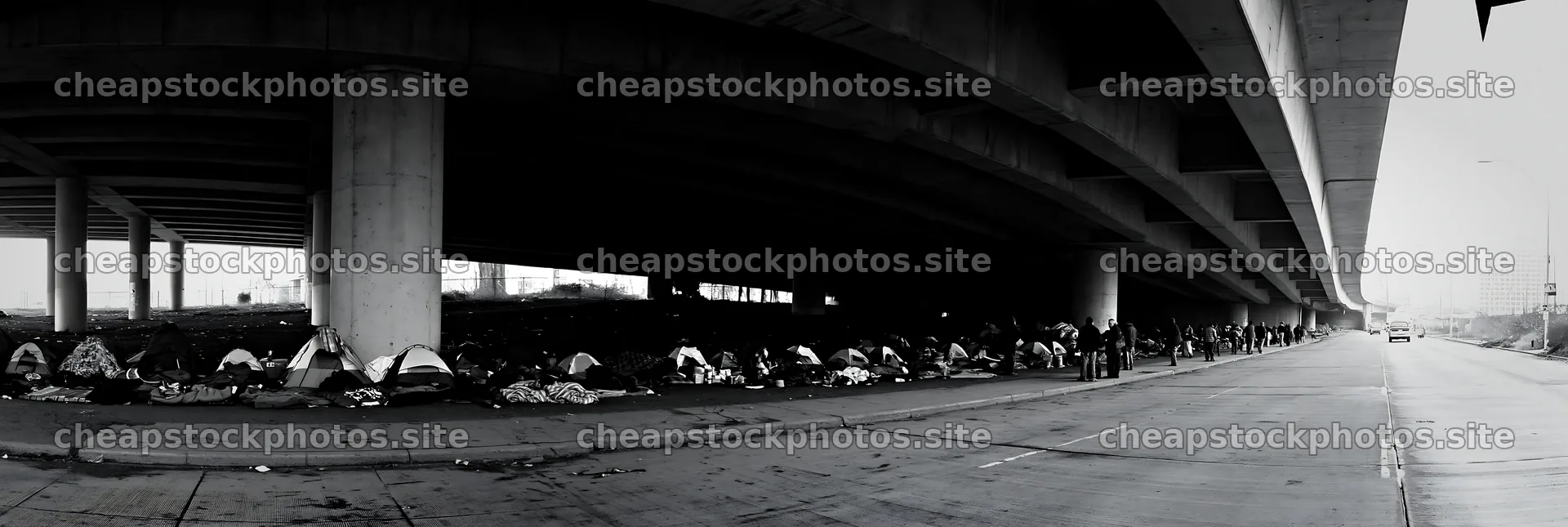 Urban poverty beneath highway infrastructure with tents and people – stock photos 13690x4602