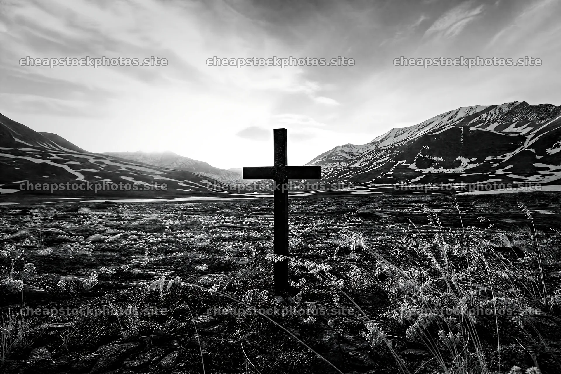 Christian cross in winter mountain meadow with distant peaks – stock photos 9722x6480