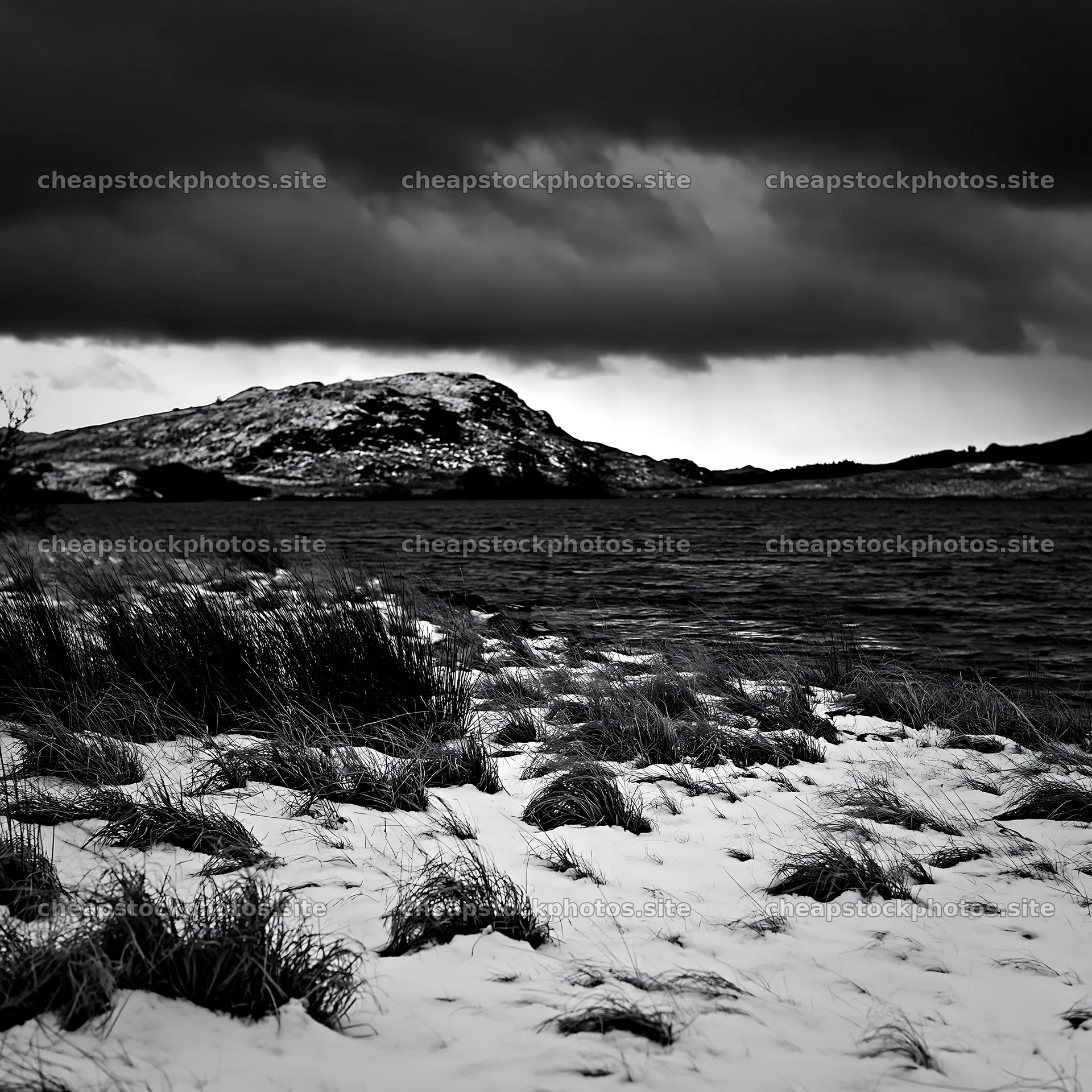 Snowy lakeside meadow with dark clouds in the background – stock photos 7938x7938