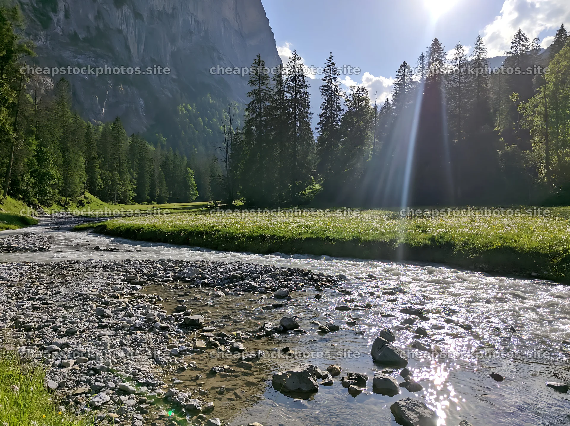 Lauterbrunnen Valley meadow with light rays and flowing water – stock photos 9174x6866