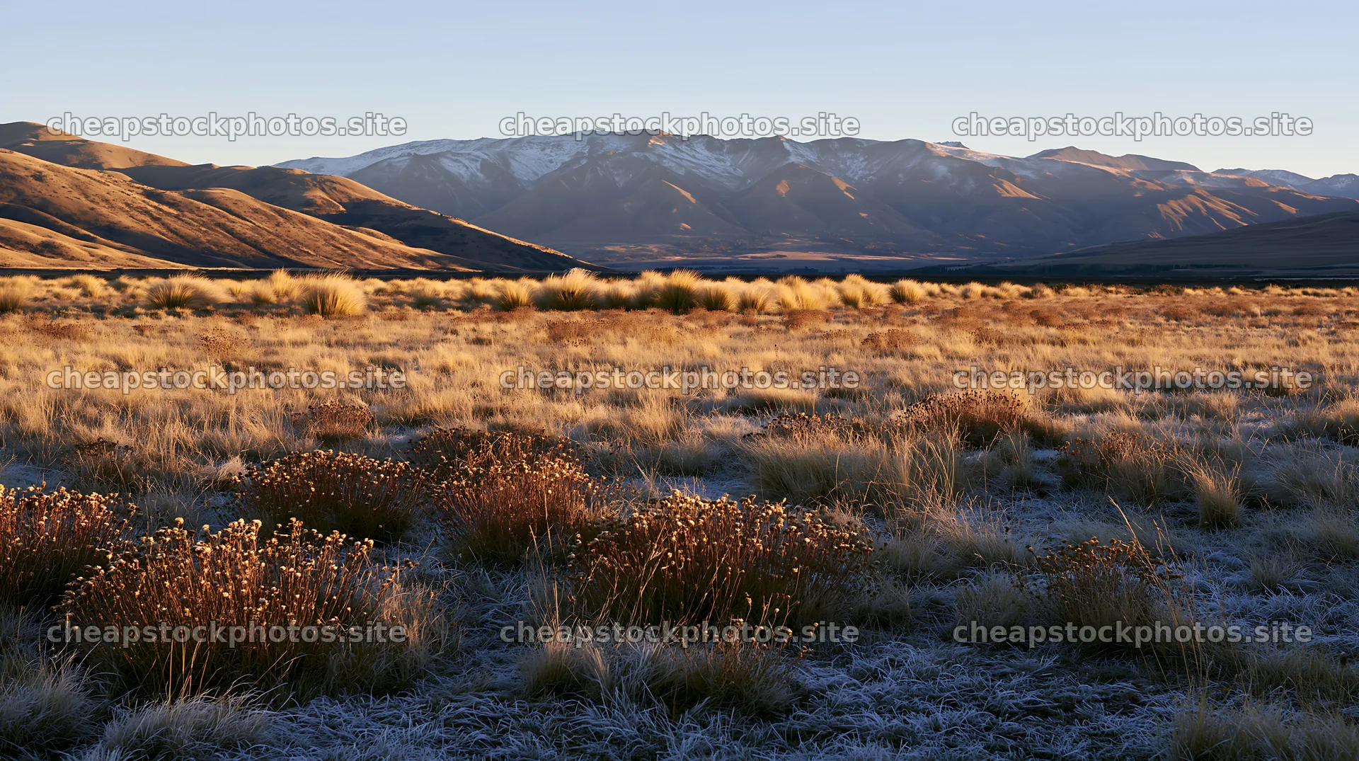 Frosty meadow at sunrise with mountains in the background – stock photos 10608x5938