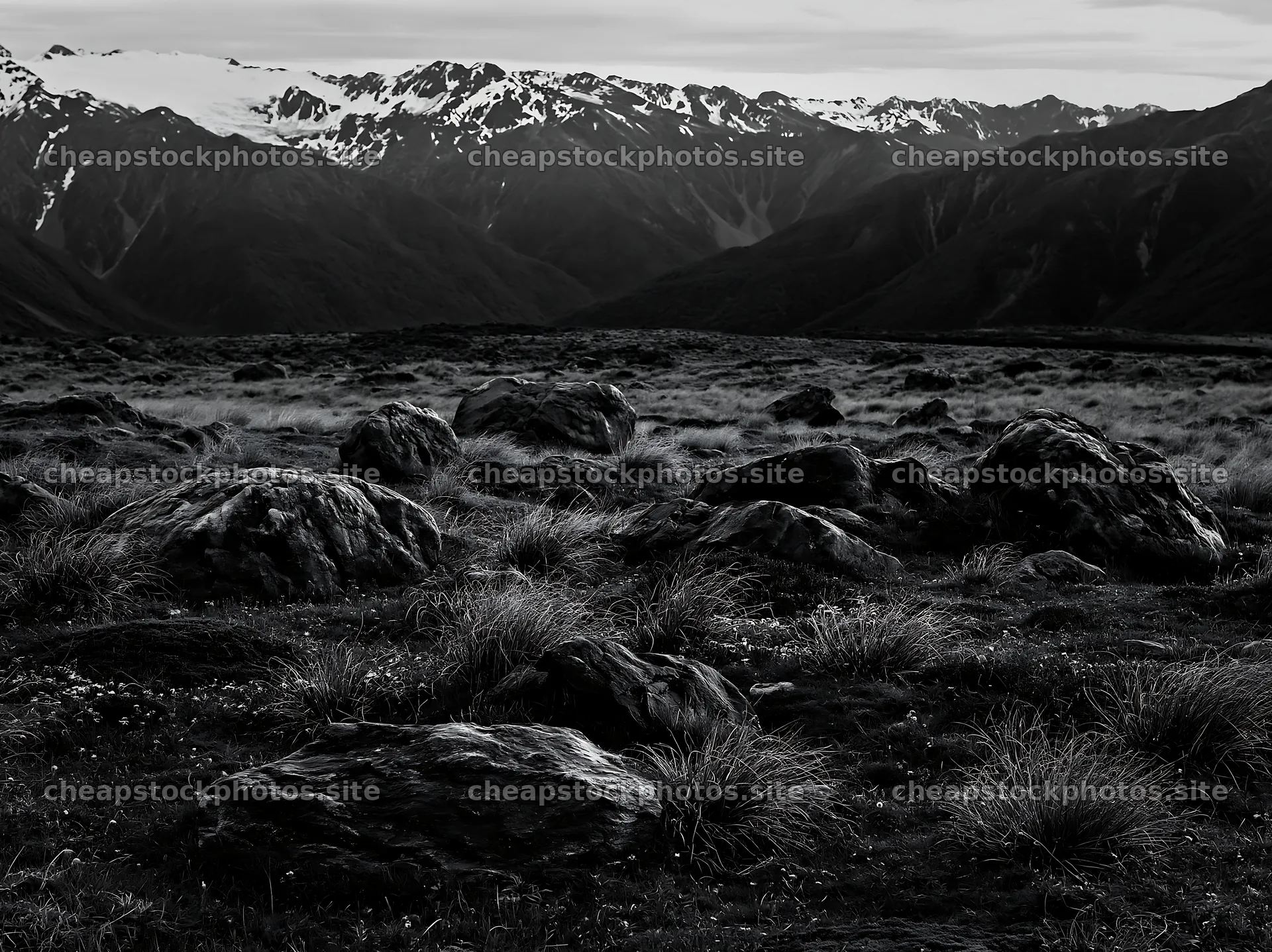 Meadow with boulders and mountains in the background – stock photos 9174x6866
