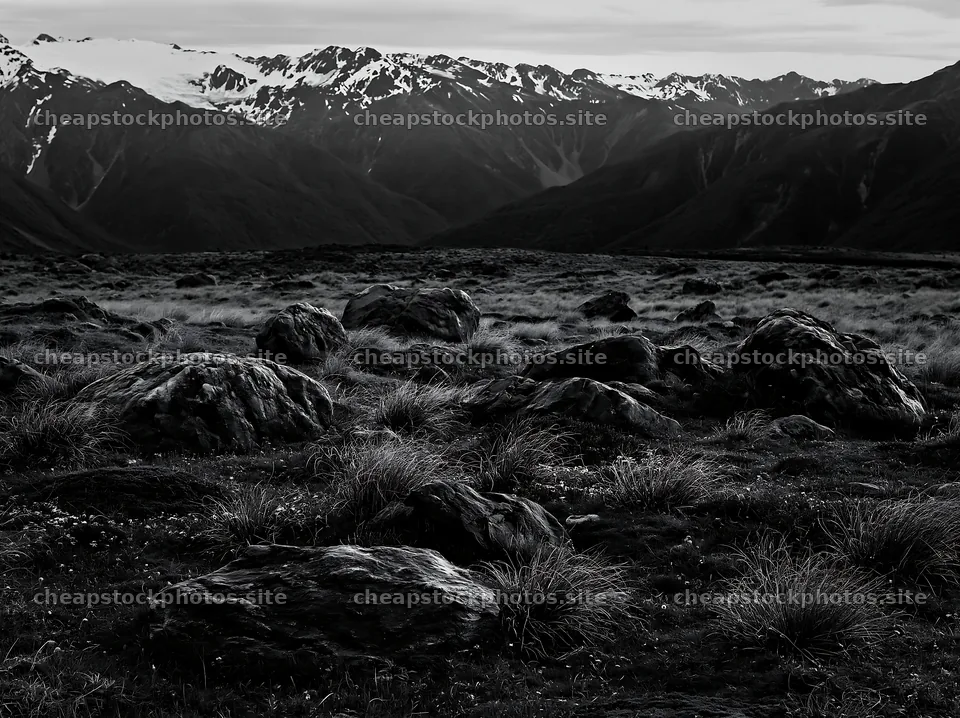 Meadow with boulders and mountains in the background – stock photos 9174x6866