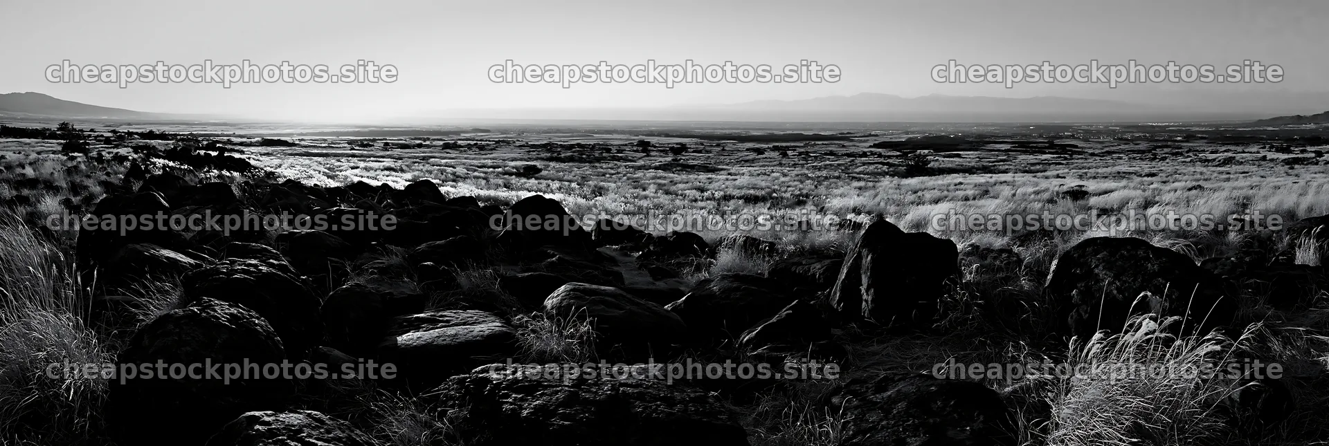Kanagawa volcanic stones in a meadow under clear skies – stock photos 13690x4602