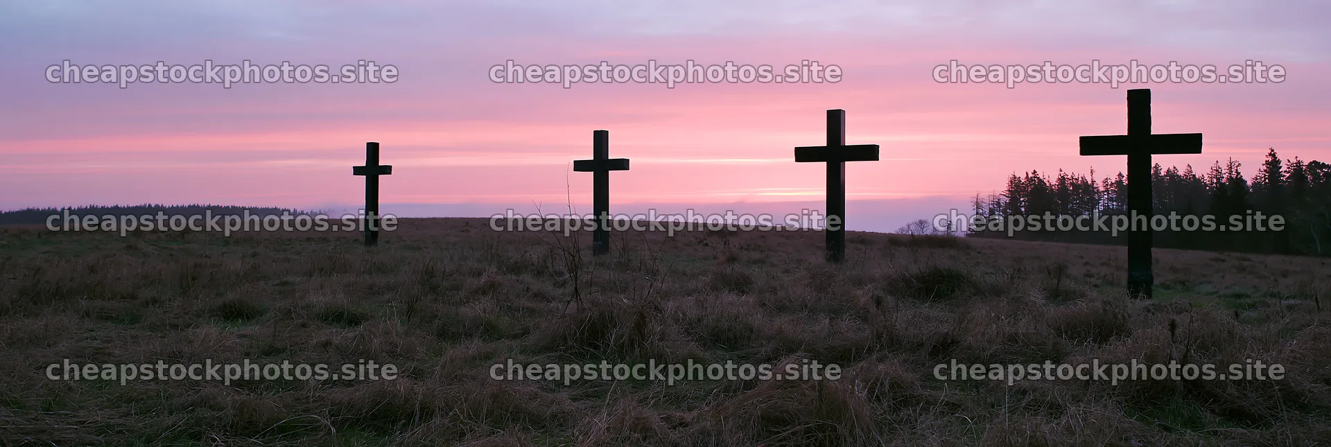 Four Christian crosses in a winter meadow at sunset – stock photos 13690x4602