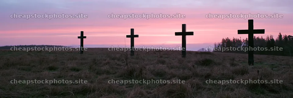 Four Christian crosses in a winter meadow at sunset – stock photos 13690x4602