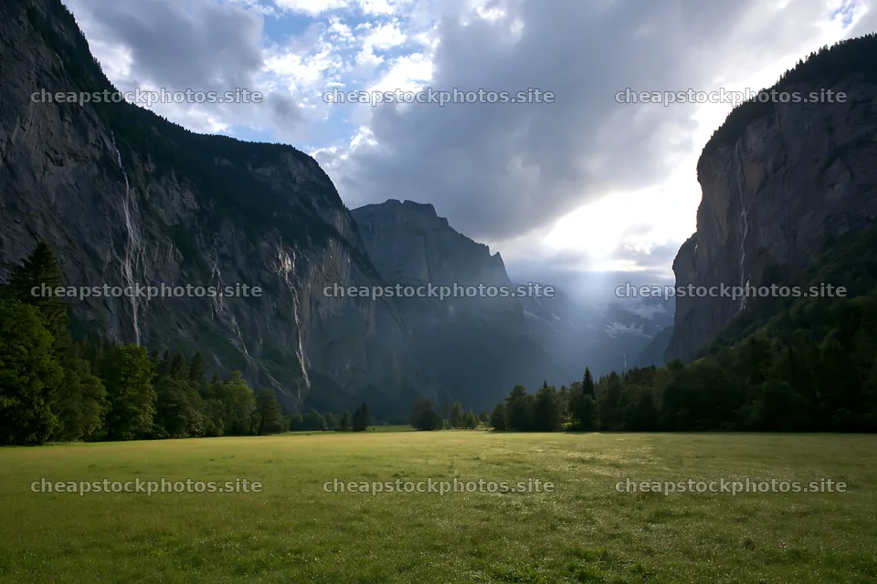 Lauterbrunnen Valley meadow light rays create dramatic landscape – stock photos 9722x6480